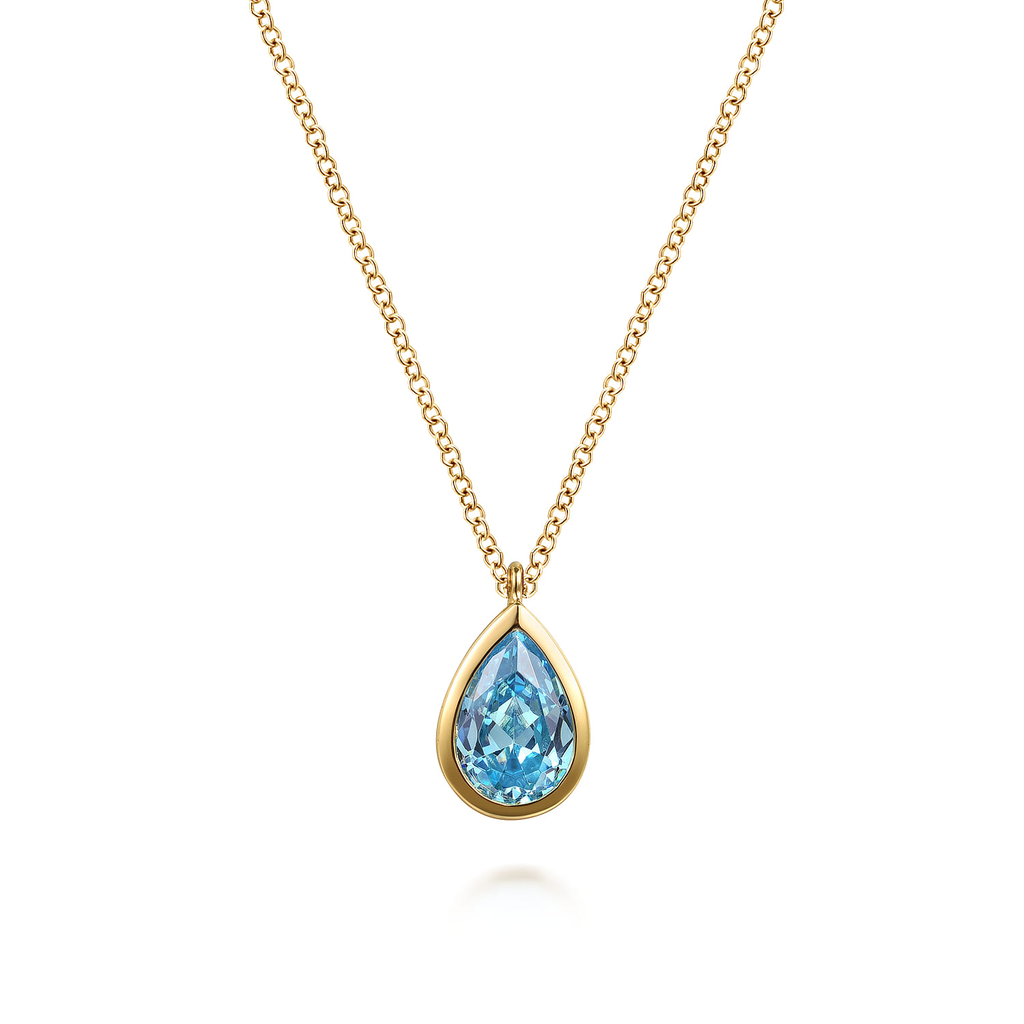 gold necklace with blue stone center on white background