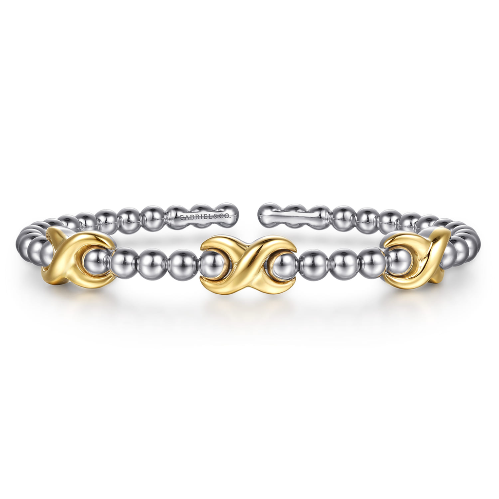 Two bracelets with gold and silver design elements on a white background