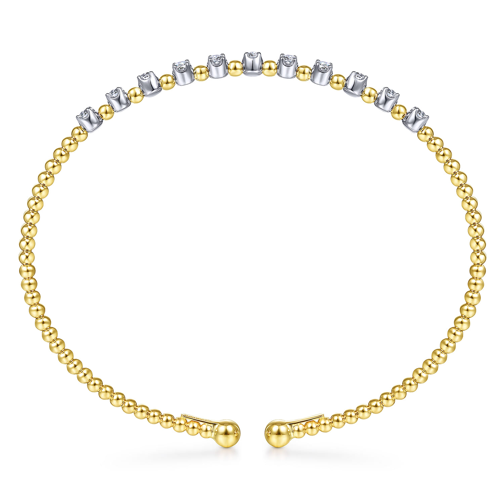 yellow bracelet with clear stone stations on white background