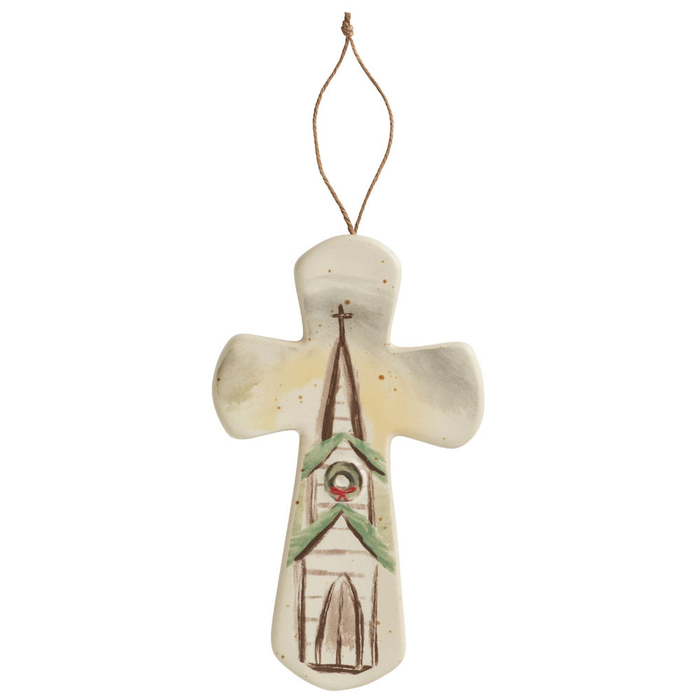 Decorative cross with a church design on a white background.