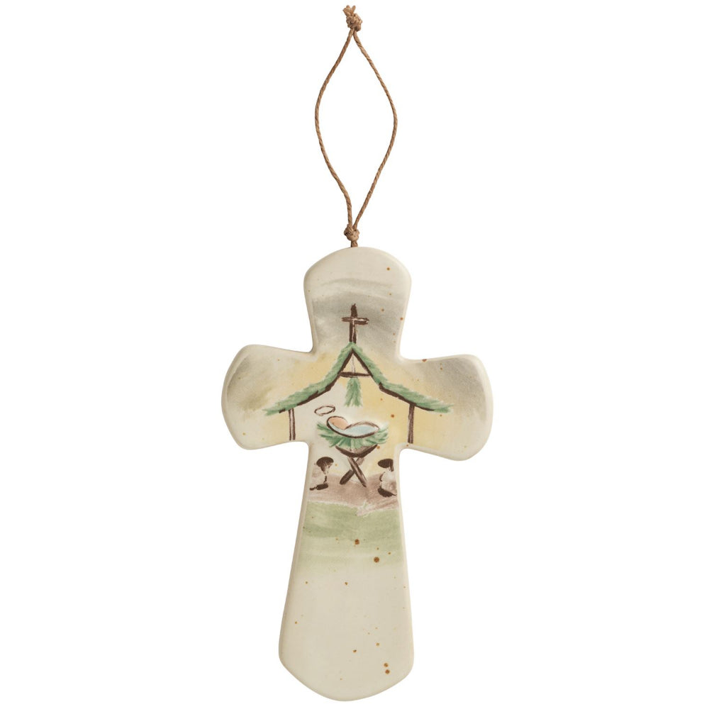 Decorative cross ornament with a design of a bird and nest on a white background.