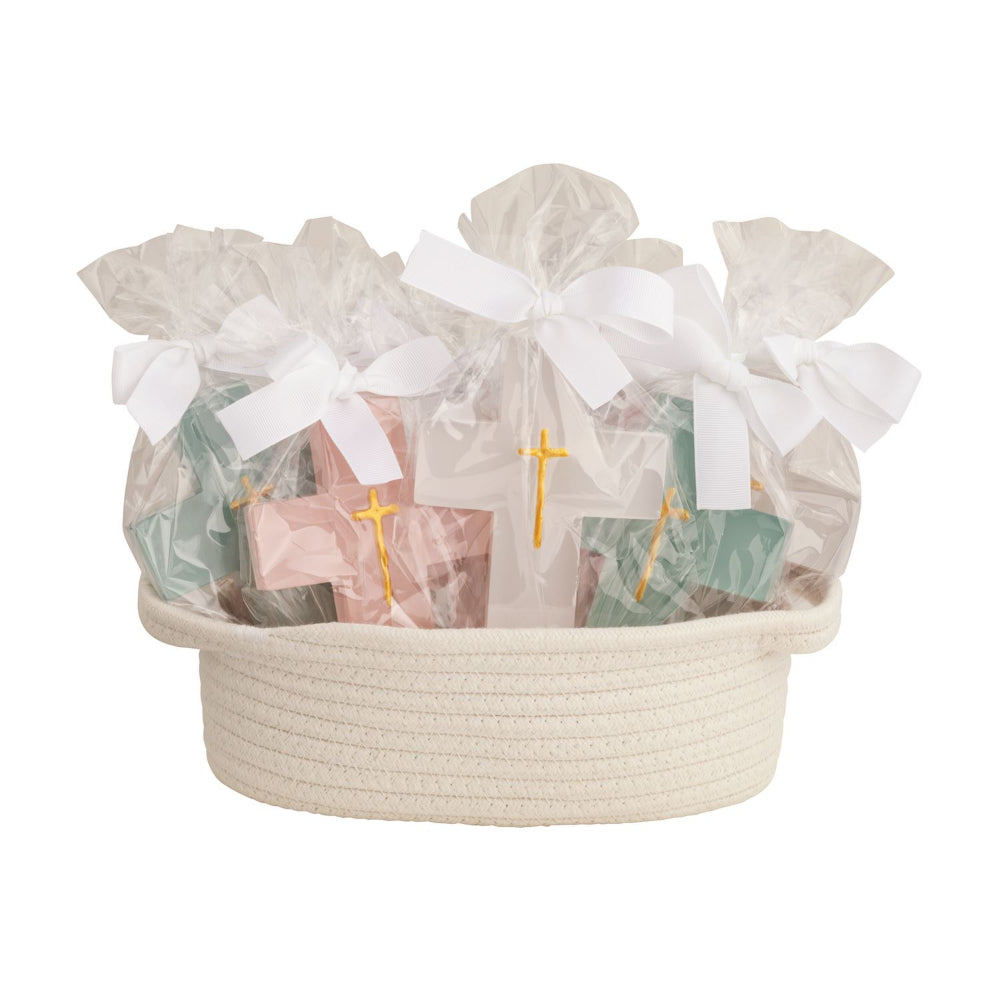 A cream-colored woven basket filled with individually wrapped cross with  white ribbons and decorated with small gold crosses, set against a plain white background.