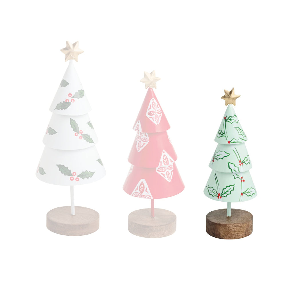 Three decorative Christmas trees on stands with white, pink, and green designs.