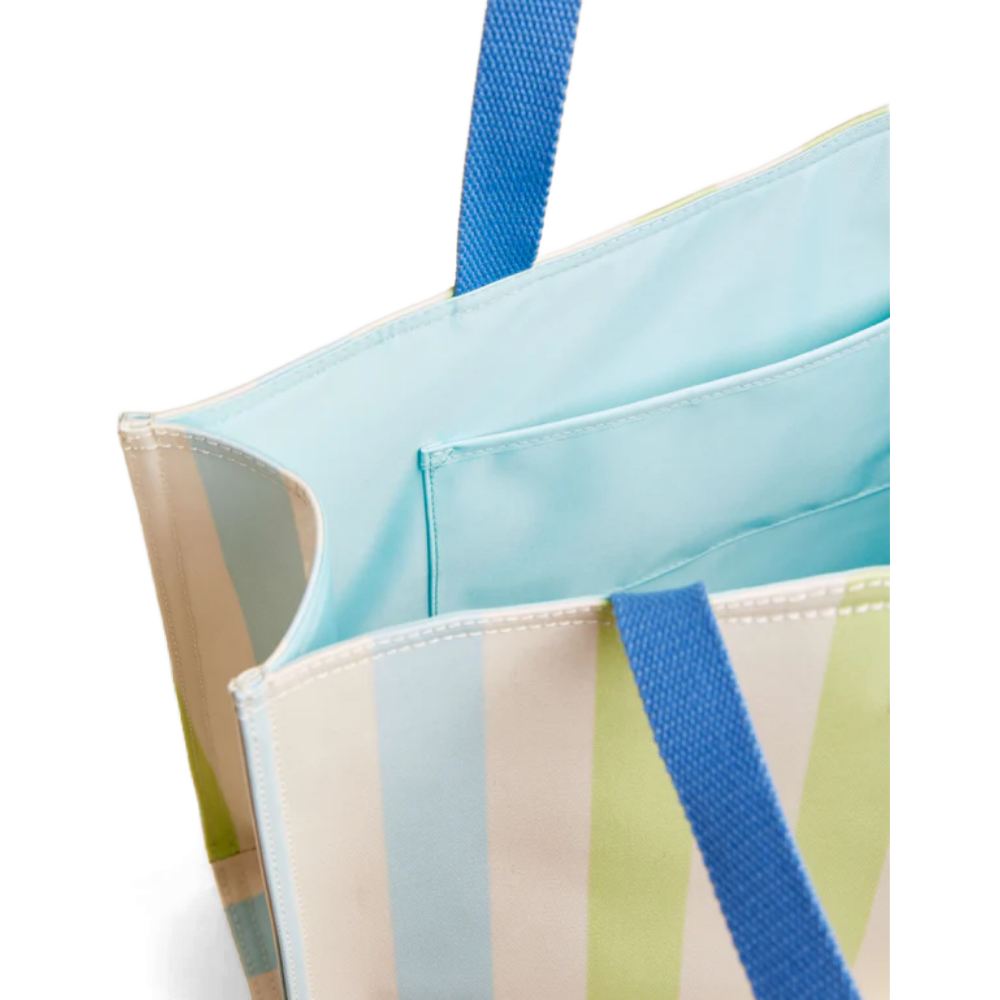 Close-up of a striped tote bag with blue handles on a white background