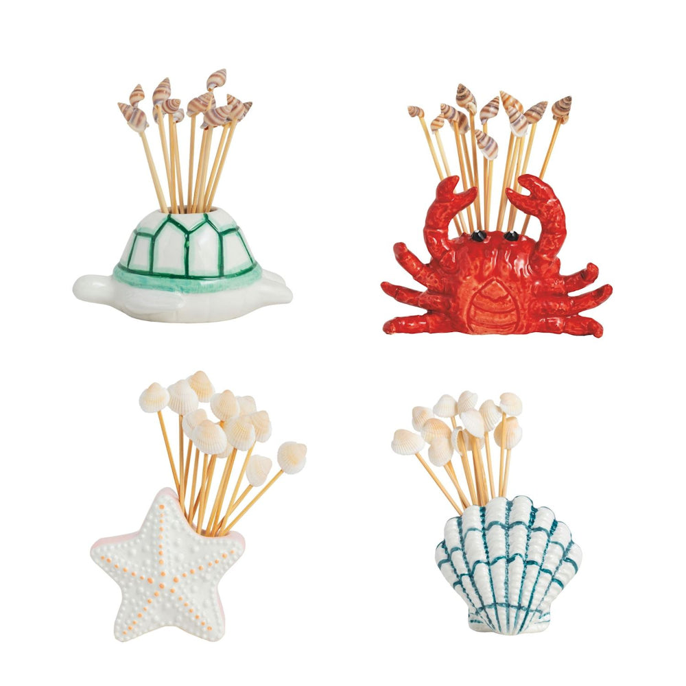 Set of four decorative toothpick holders shaped like a turtle, crab, starfish, and shell on a white background.