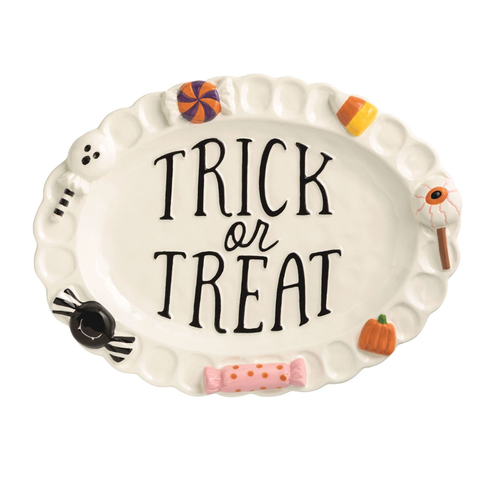 Halloween-themed ceramic plate with 'Trick or Treat' text and candy designs on a white background