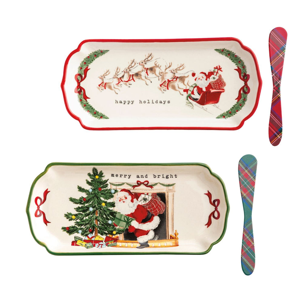 Set of Christmas-themed trays and cutlery with Santa Claus designs on a white background.