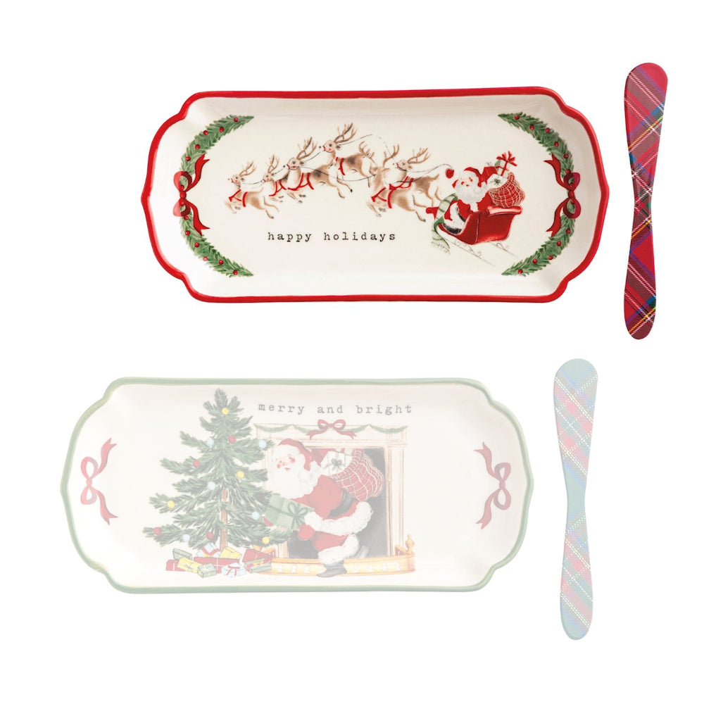 Set of Christmas-themed trays and cutlery with Santa Claus designs on a white background.