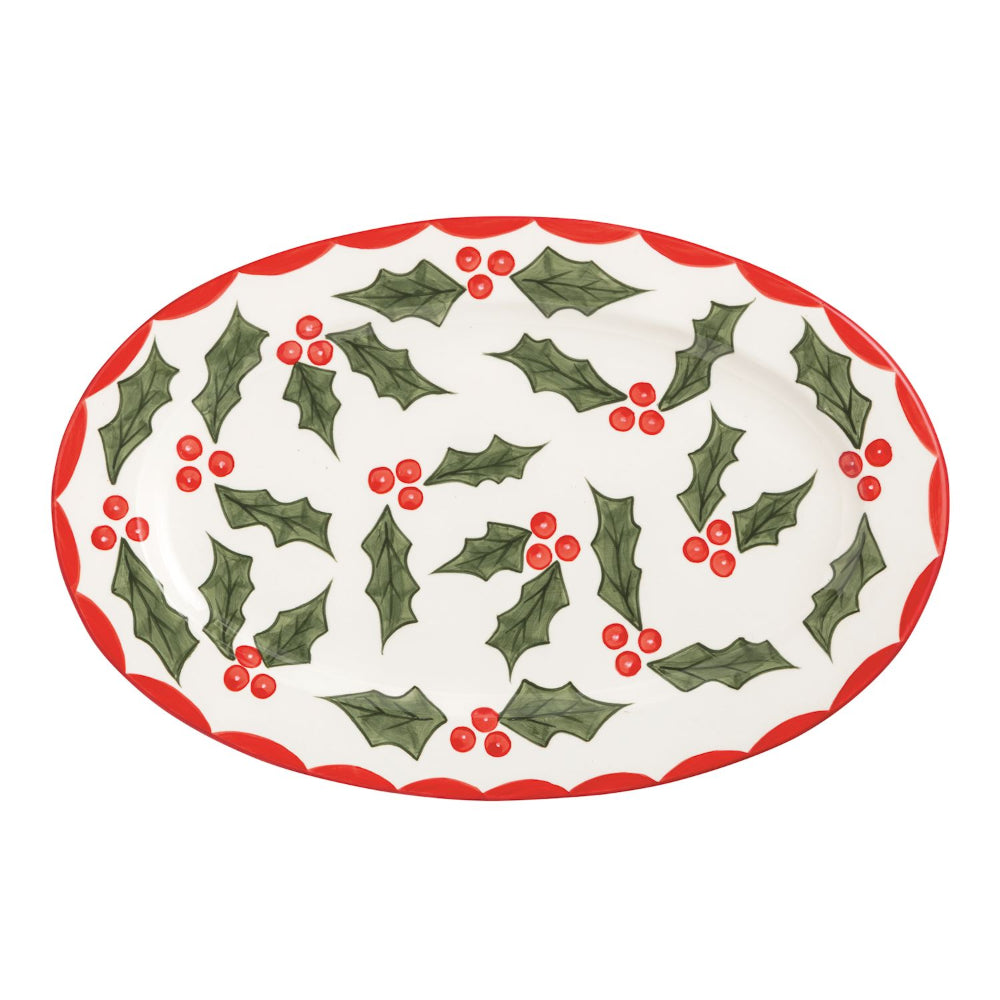 Decorative plate with holly design on a white background