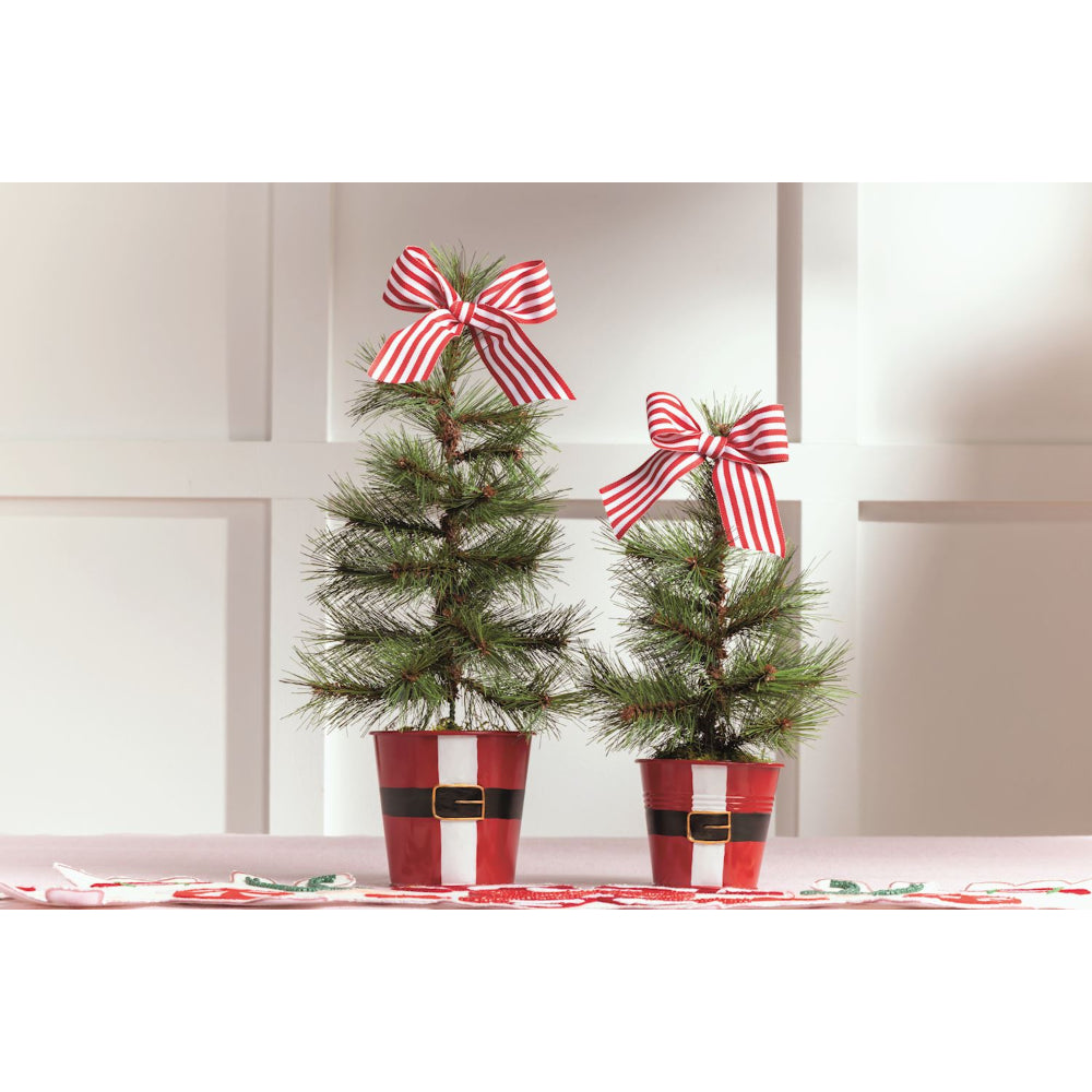 Two small Christmas trees with red and white striped bows on a neutral background