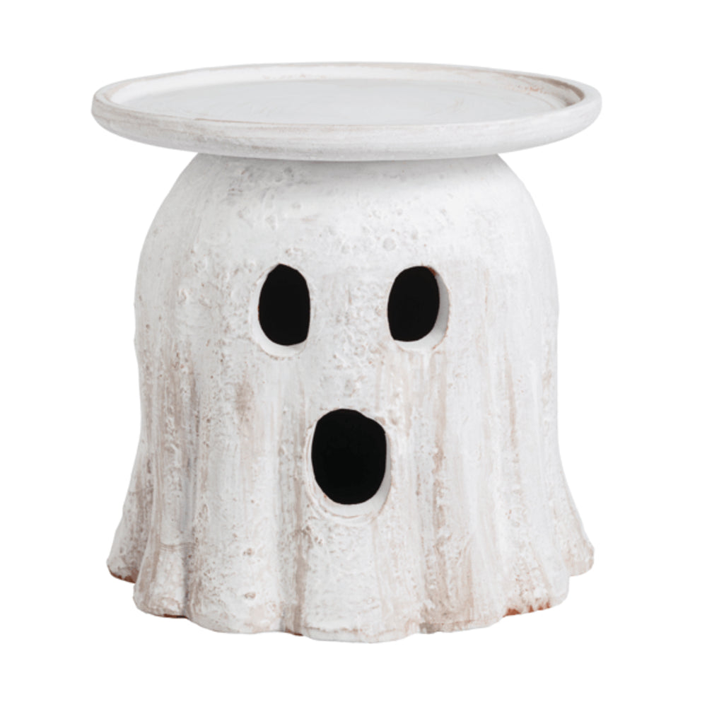 White ghost-shaped candle holder with black eyes and mouth on a white background