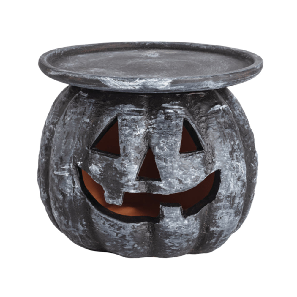 Halloween-themed candle holder with jack-o'-lantern face on a white background