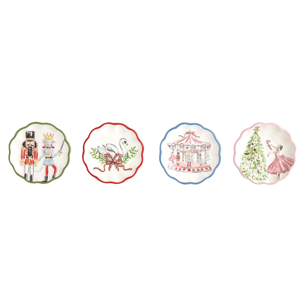 Four decorative ceramic plates with scalloped edges, each featuring a different whimsical illustration: a nutcracker and princess, a swan in a red border, a carousel with a blue border, and a ballerina decorating a Christmas tree with a pink border.