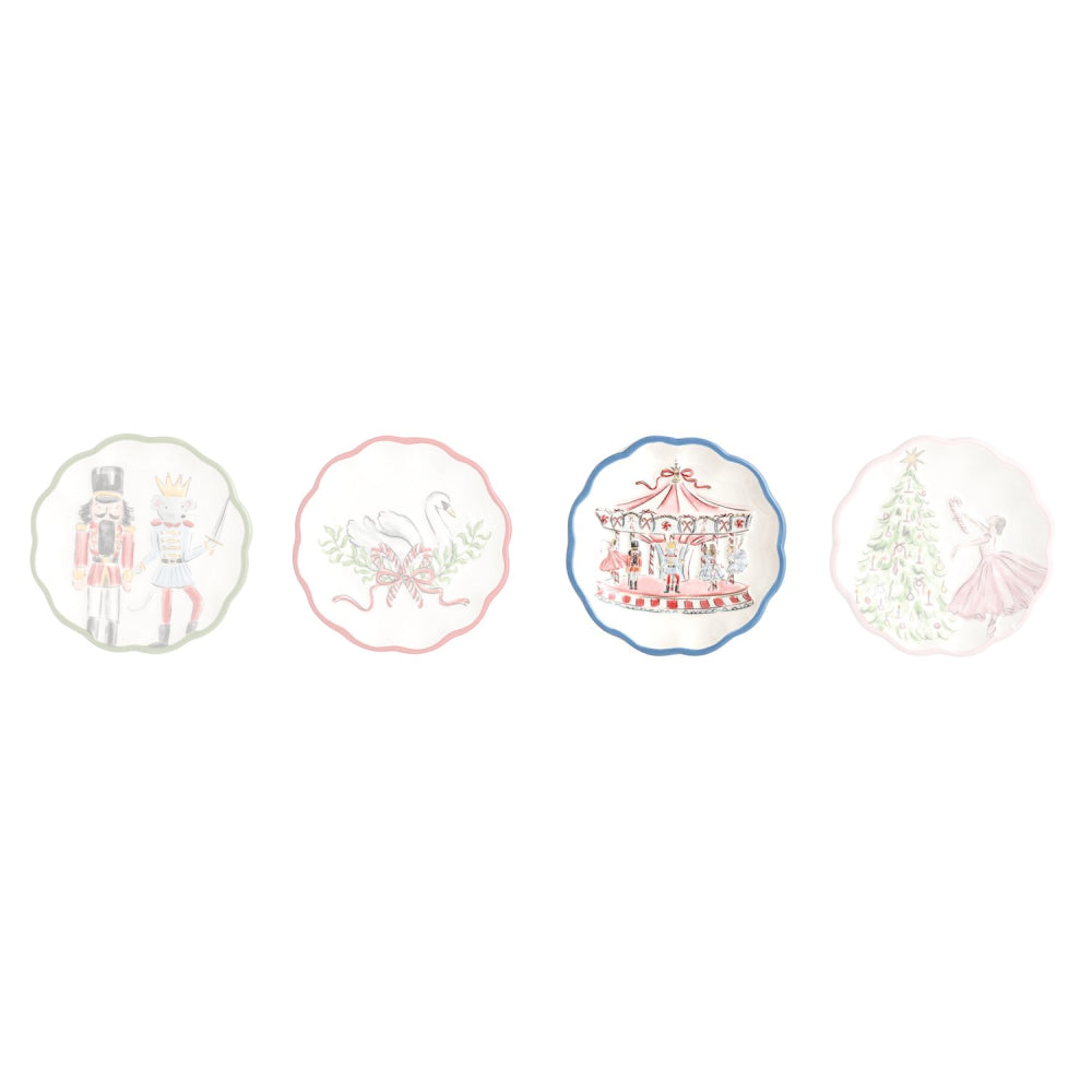 Four decorative ceramic plates with scalloped edges, each featuring a different whimsical illustration on a white background: a nutcracker, a swan, a carousel, and a Christmas tree.