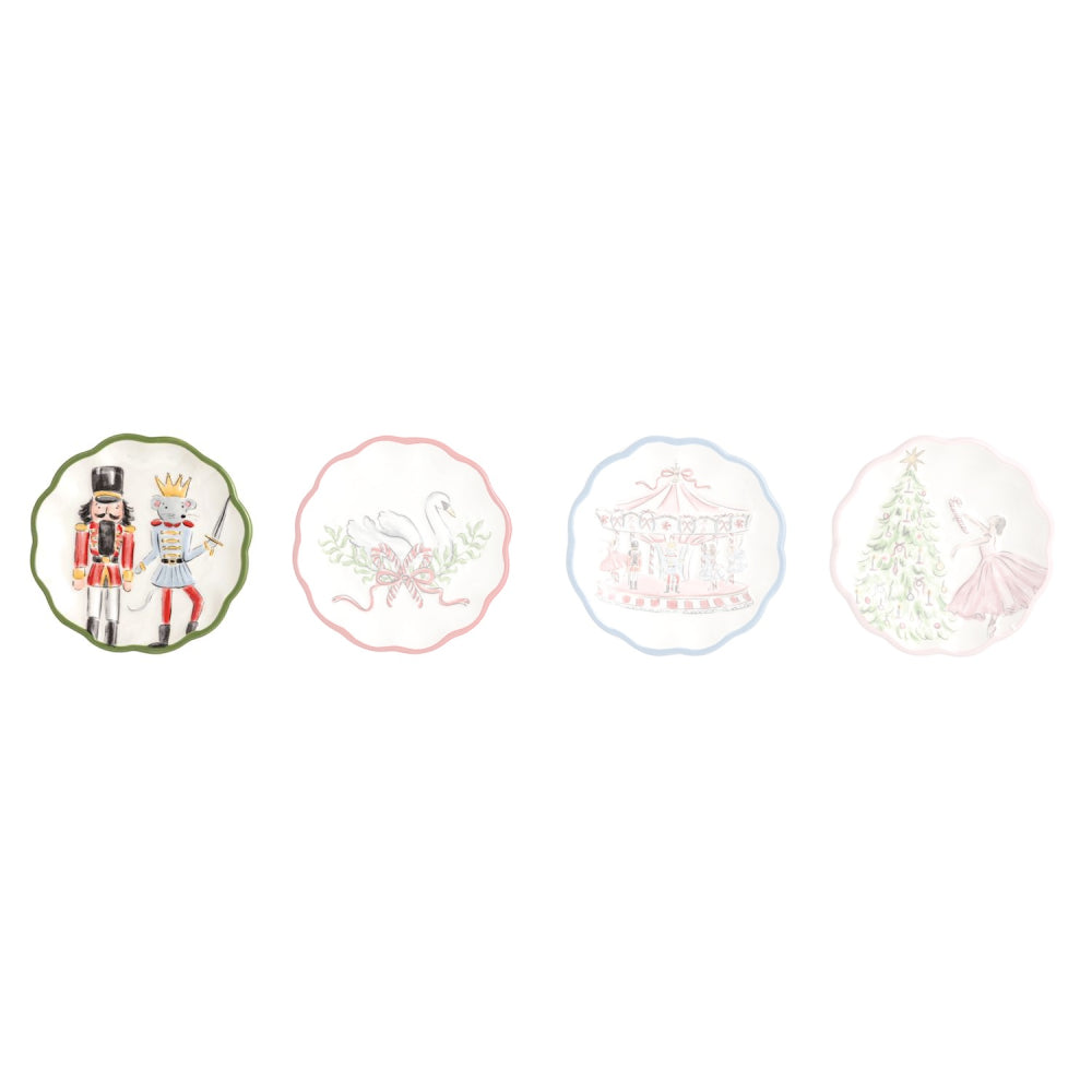 Four decorative ceramic plates with scalloped edges, each featuring a different whimsical illustration on a white background: a nutcracker and princess, a swan, a carousel, and a ballerina by a Christmas tree.