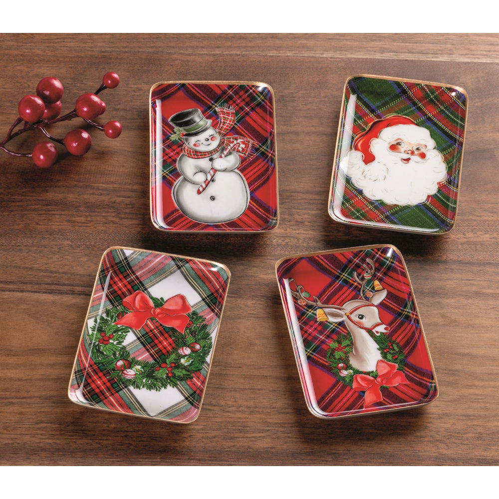 Four rectangular Christmas-themed trays with Santa, reindeer, wreath, and snowman designs on a white background.
