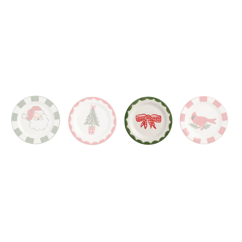 Four small round ceramic plates with holiday designs, arranged in a row on a white background. The plates feature scalloped edges and illustrations of a Santa Claus face, a Christmas tree with a gift box, a red gift bow, and a pink bird.