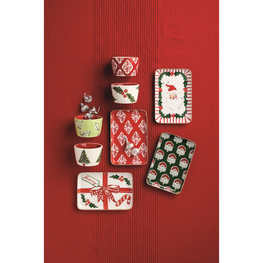 Set of Christmas-themed plates on a red background