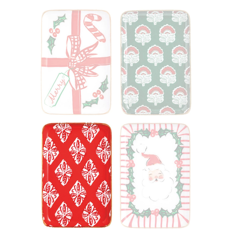 Set of Christmas-themed ceramic dishes on a red background