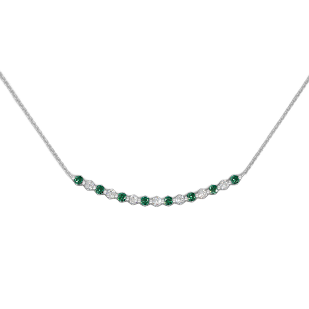 White gold emerald and diamond smile pendant necklace with small diamonds on a white background