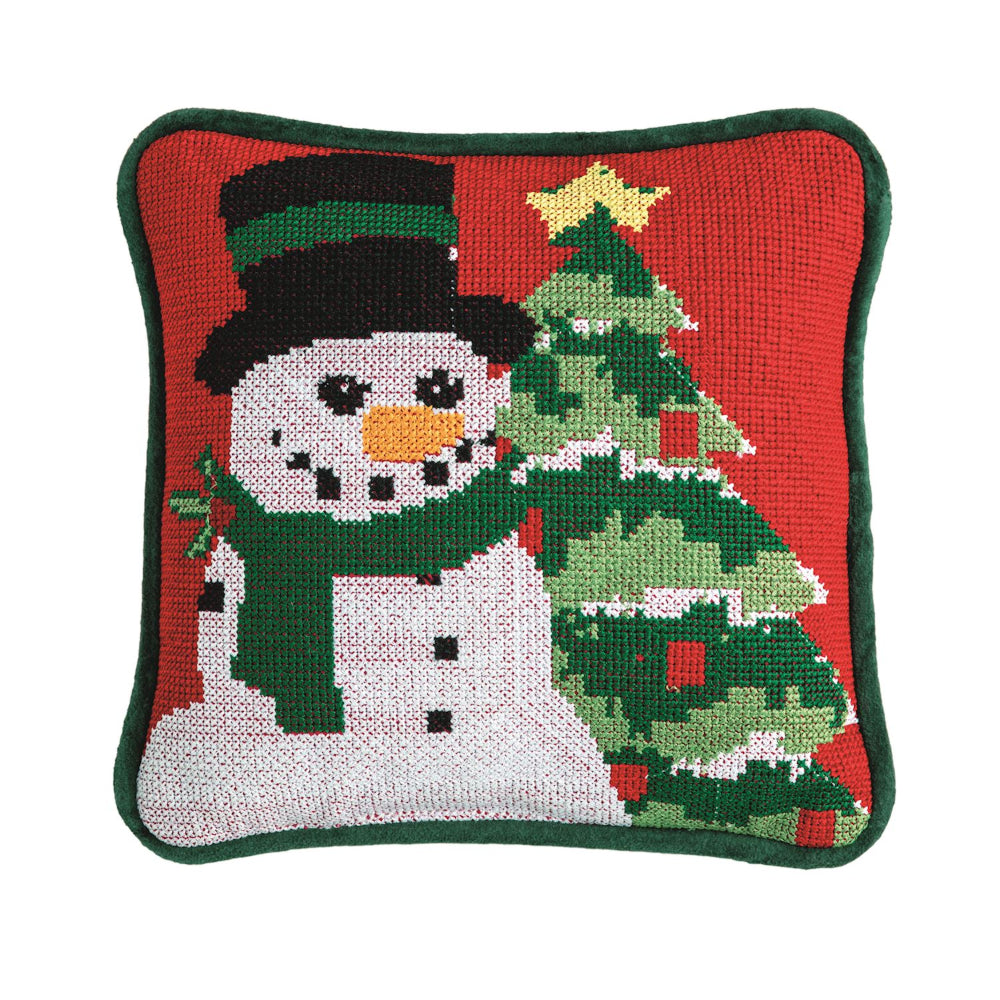 Decorative pillow with a snowman and Christmas tree design on a red background