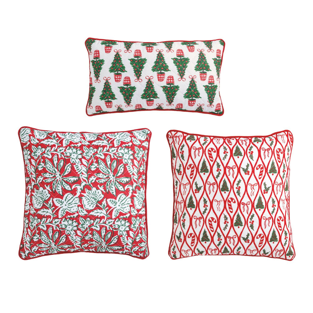 Three Christmas-themed decorative pillows on a white background