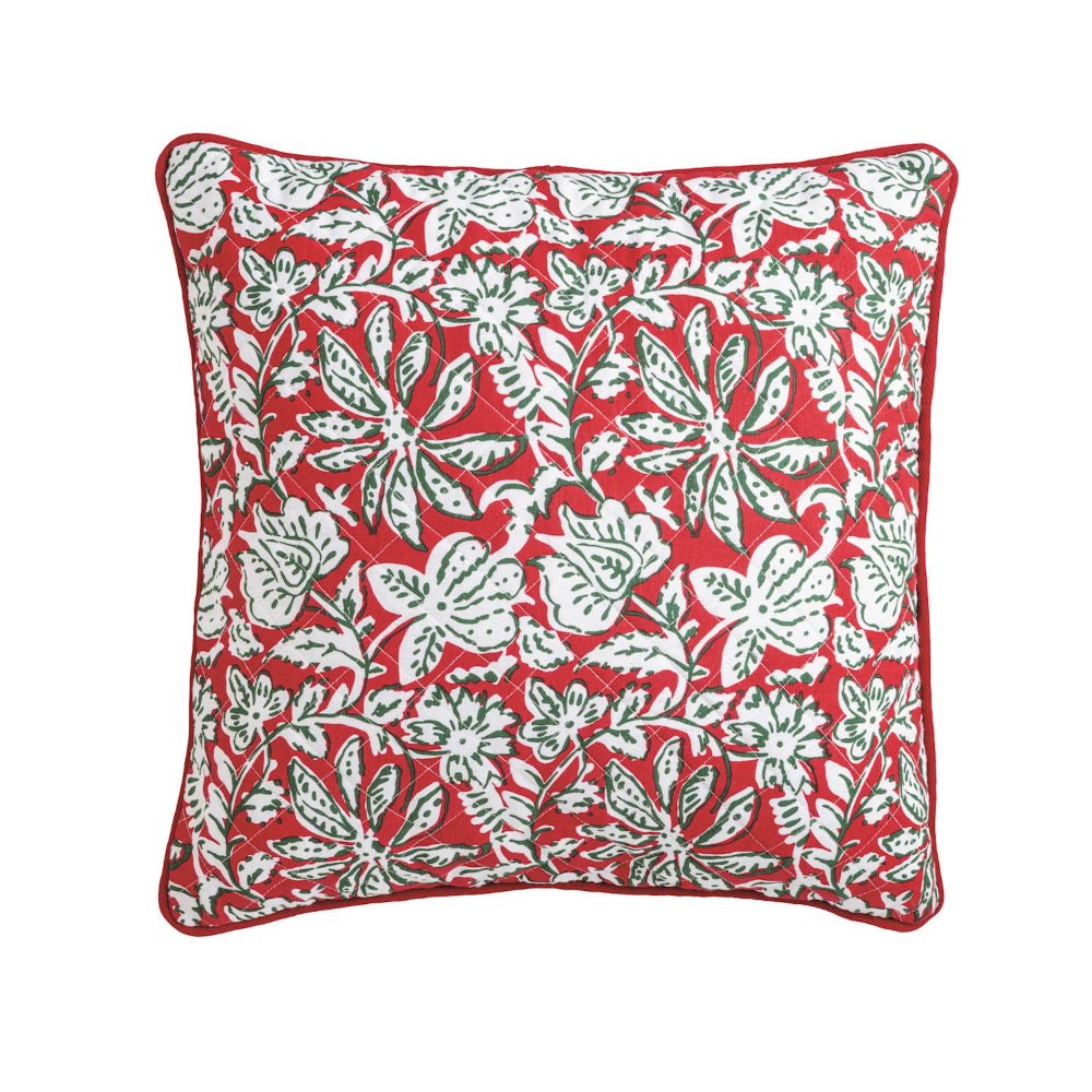 Red pillow with white floral pattern on a white background