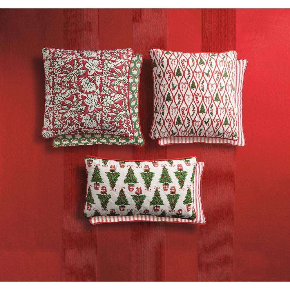 Three decorative pillows with Christmas patterns on a red background