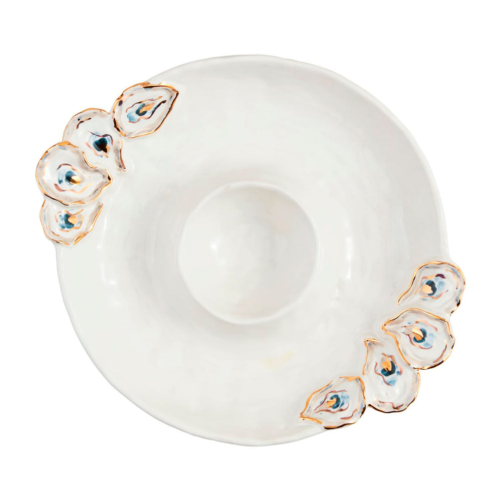 Decorative white saucer with peacock feather design on a white background.
