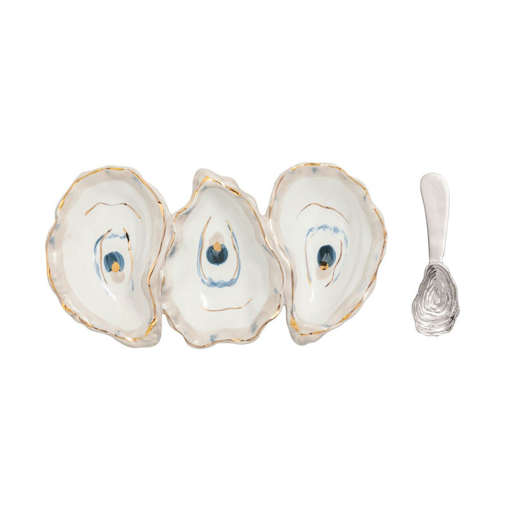 Three oyster shells with a small fork on a white background.