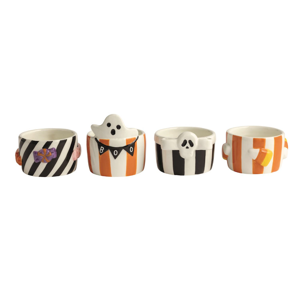 Set of four Halloween-themed ceramic cups with ghost and striped designs on a white background