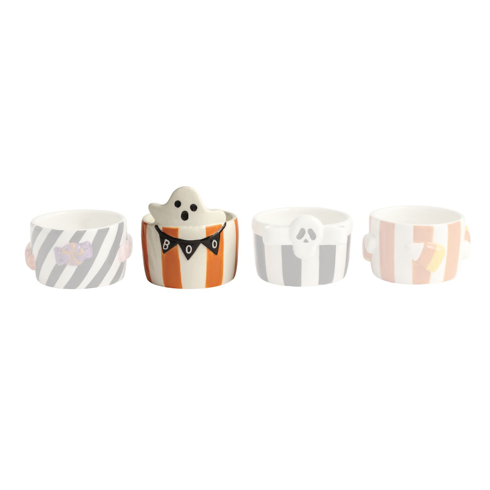 Set of four small Halloween-themed ceramic cups on a white background