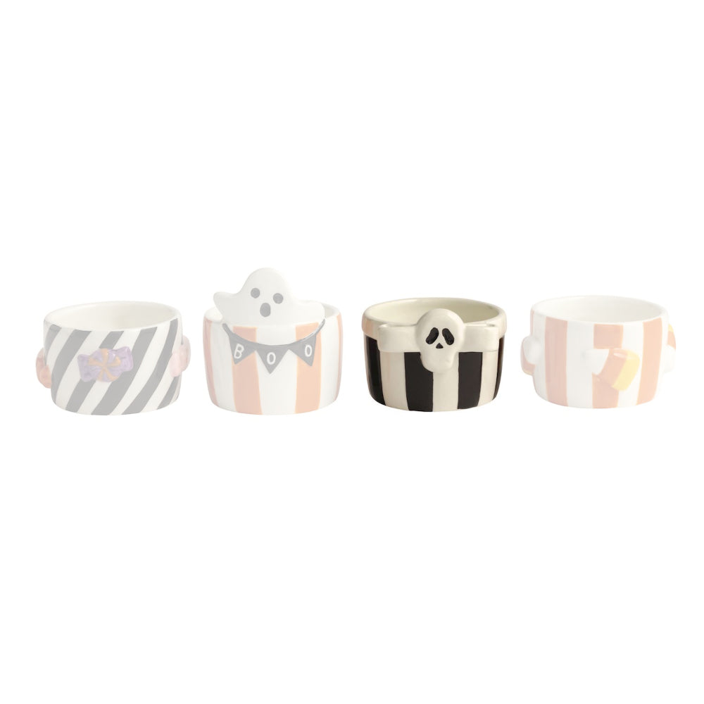 Set of four small ceramic cups with Halloween-themed designs on a white background