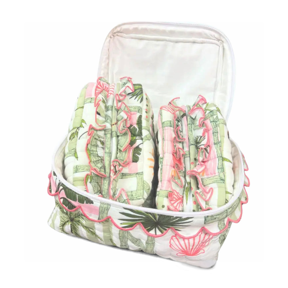 Two green and pink patterned cosmetic bags with a large cosmetic bag around it on a white background