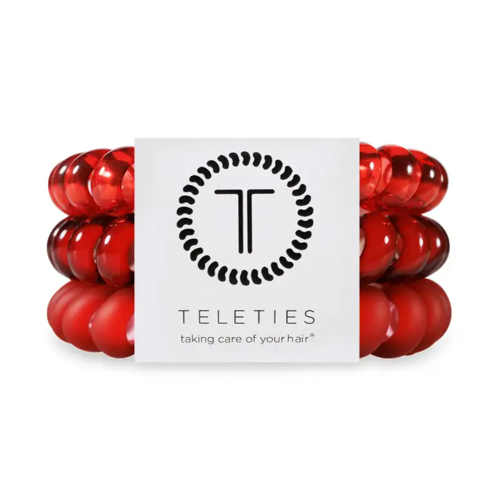 Red hair ties with a white label featuring the 'TELETIES' logo on a white background