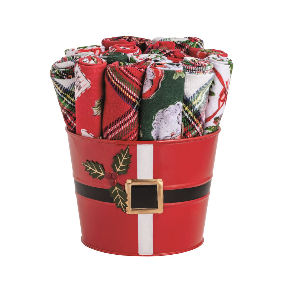 A set of rolled Christmas-themed bandanas displayed inside a red metal bucket with a black belt and gold buckle design, on a solid white background.