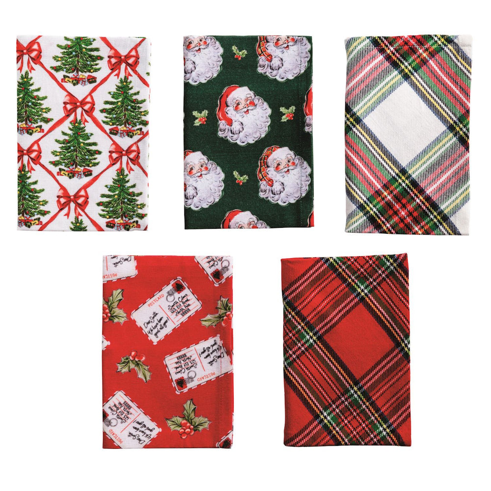 Five Christmas-themed fabric napkins or small towels shown on a plain white background, featuring holiday prints including Christmas trees with red bows, Santa Claus faces, a green plaid pattern, red gift tags, and red tartan plaid.