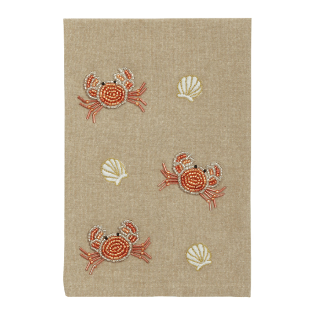 Beige  crab hand towel with and shell patterns on a white background.