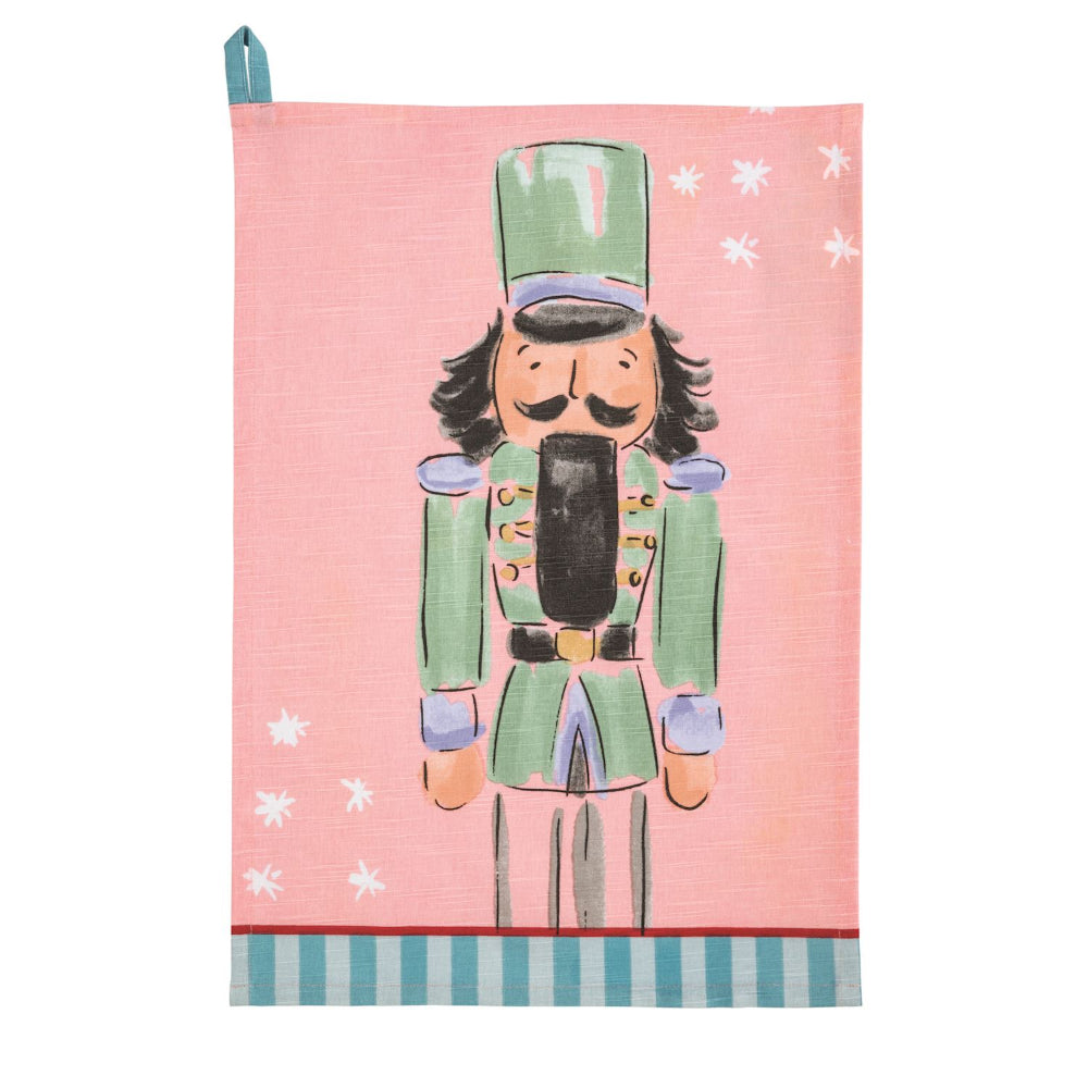 Tea towel with a nutcracker design on a pink background