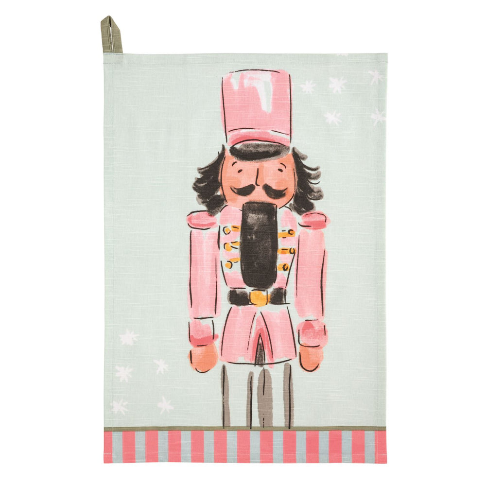 Tea towel with a nutcracker design on a light green background