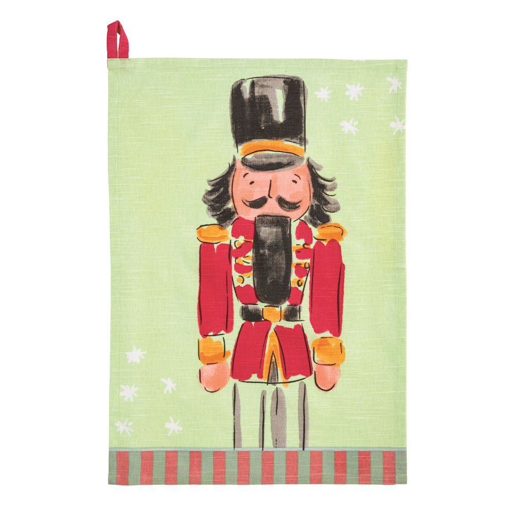 Tea towel with a nutcracker design on a light green background