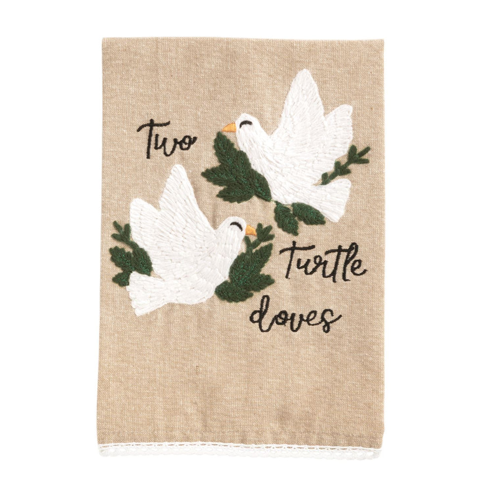 Decorative towel with embroidered white doves and text on a beige background