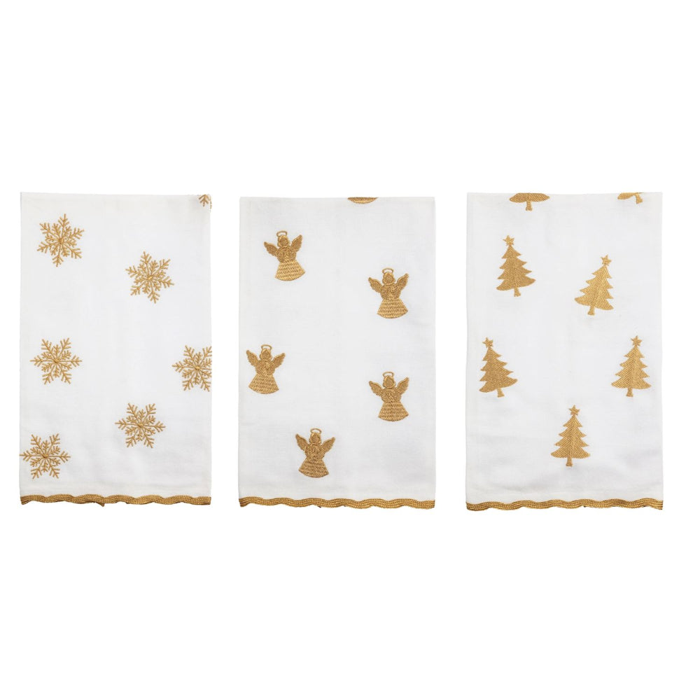 Three white towels with gold Christmas patterns on a white background