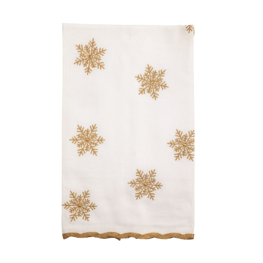 White towel with gold snowflake patterns on a white background