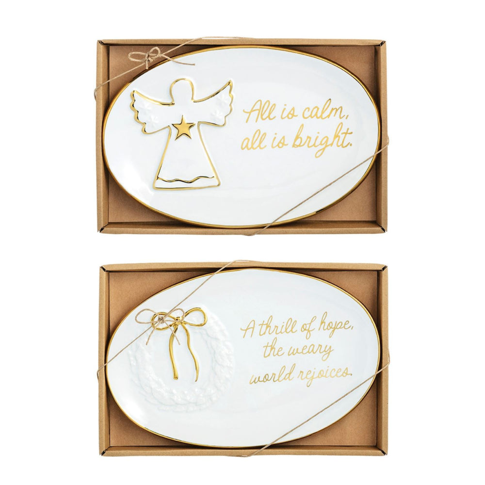Two white ceramic plates with gold angel and bow designs, each with a Christmas message, in brown packaging.
