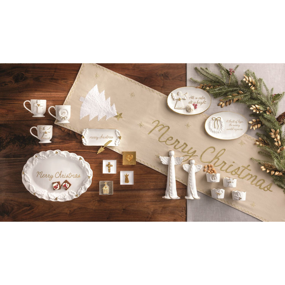Decorative Christmas items including plates, cups, and ornaments on a wooden surface.