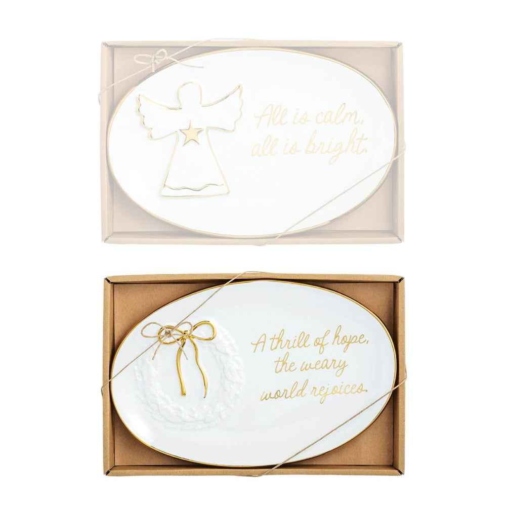 Two decorative plates with angel and bow designs in gift boxes on a white background