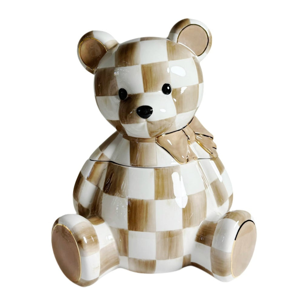 A ceramic teddy bear container with a glossy brown and white checkered pattern, featuring a small bow on its neck, set against a plain white background.