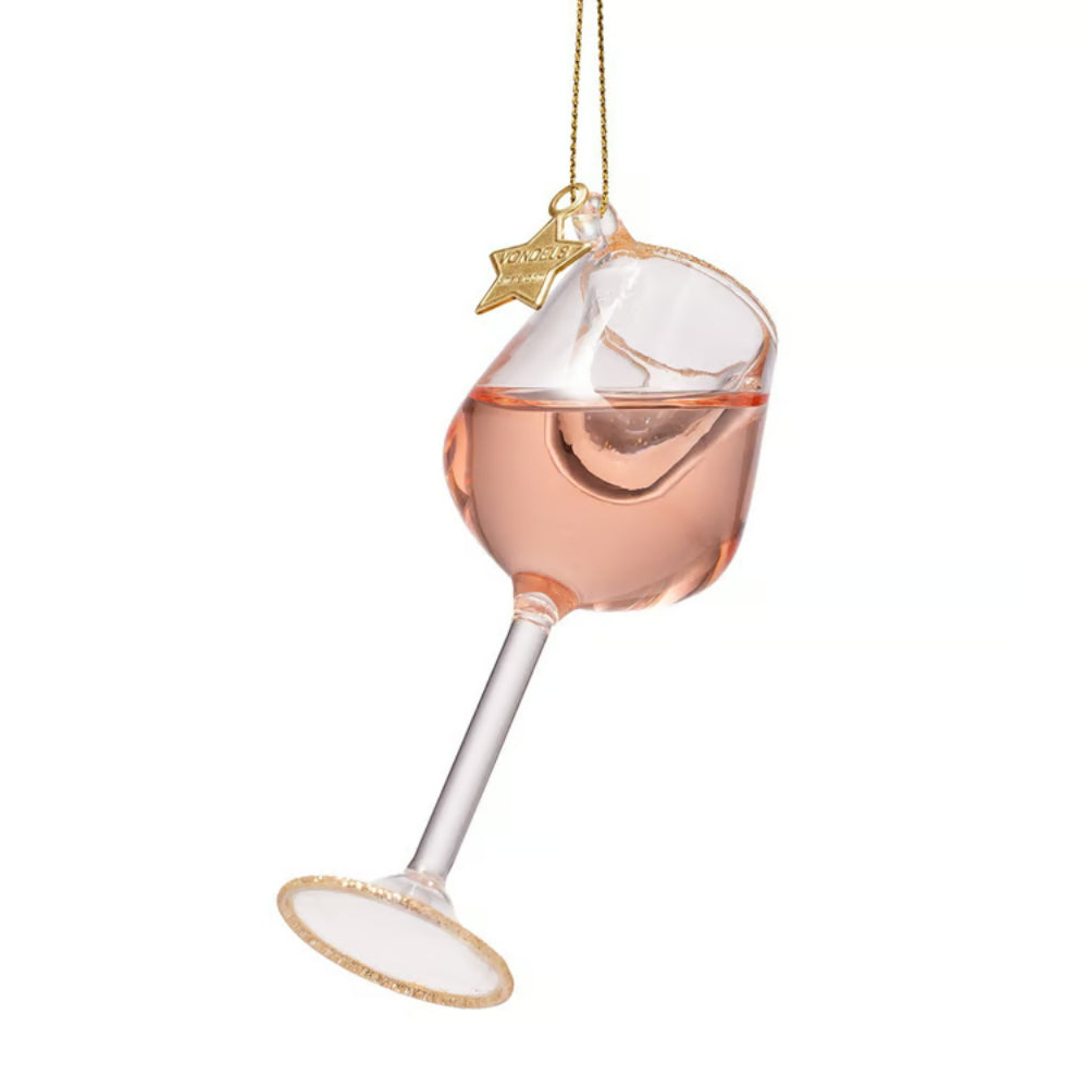 A hanging ornament shaped like a tilted wine glass filled with pink liquid, with a gold hanging string and a small gold star charm that reads 'Proudly Pink,' shown on a plain white background.