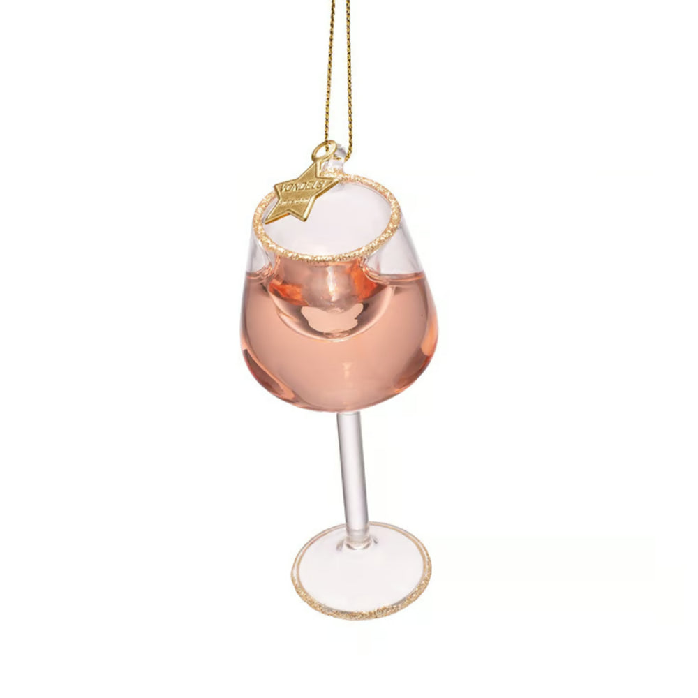 A wine glass Christmas ornament filled with pink liquid, featuring a gold glittery rim, a hanging gold string, and a small gold star ornament at the top, set against a plain white background.